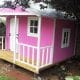 Colorful pink dollhouse on stilts