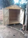 Empty wooden shed with open doors